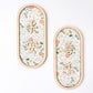 Two oval wooden wall plaques with floral patterns and Chinese characters, displayed on a clean white background.